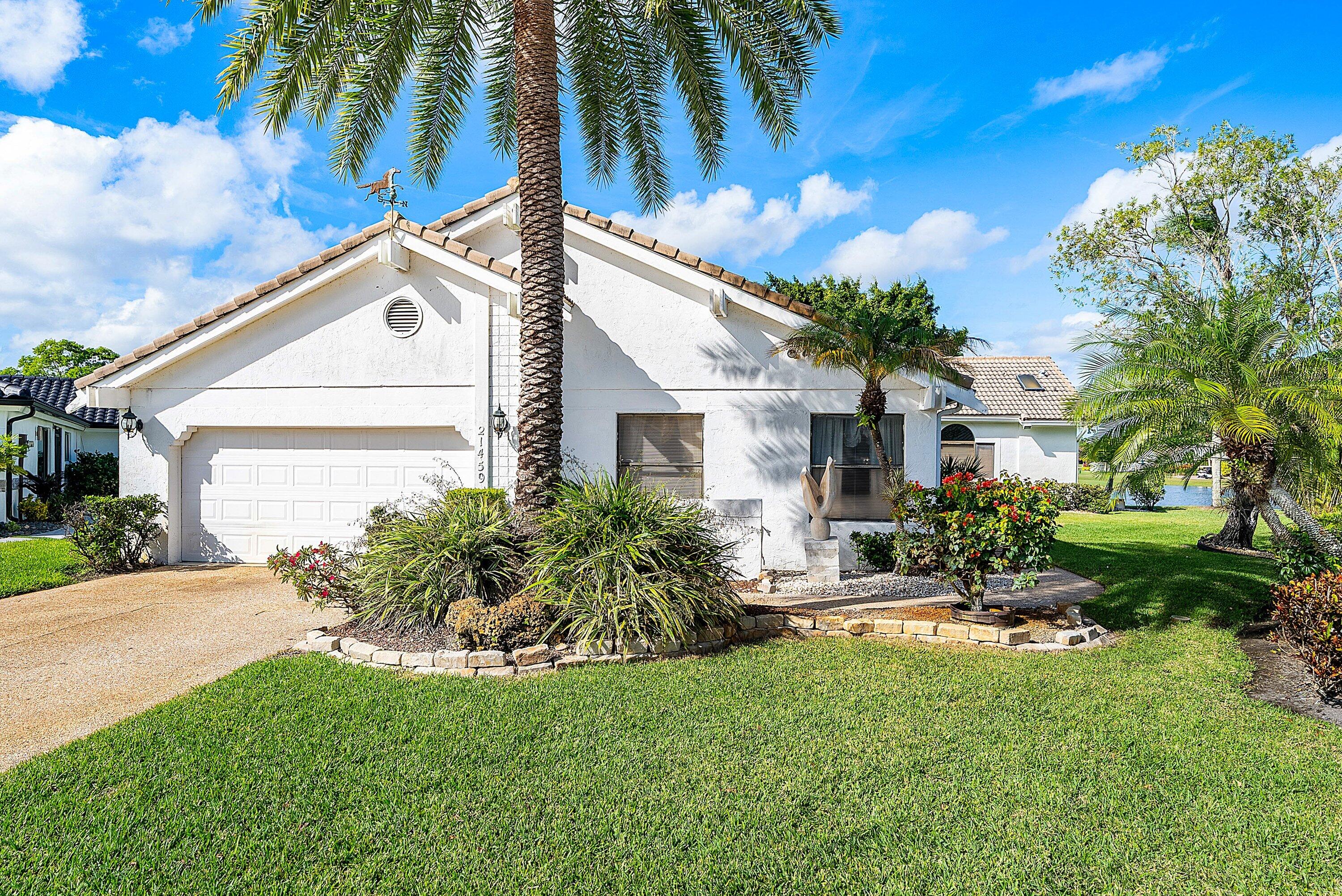 21459 Bridgeview Drive Boca Raton, FL 33428 - Photo 4 of 61 a front view of a house with a yard