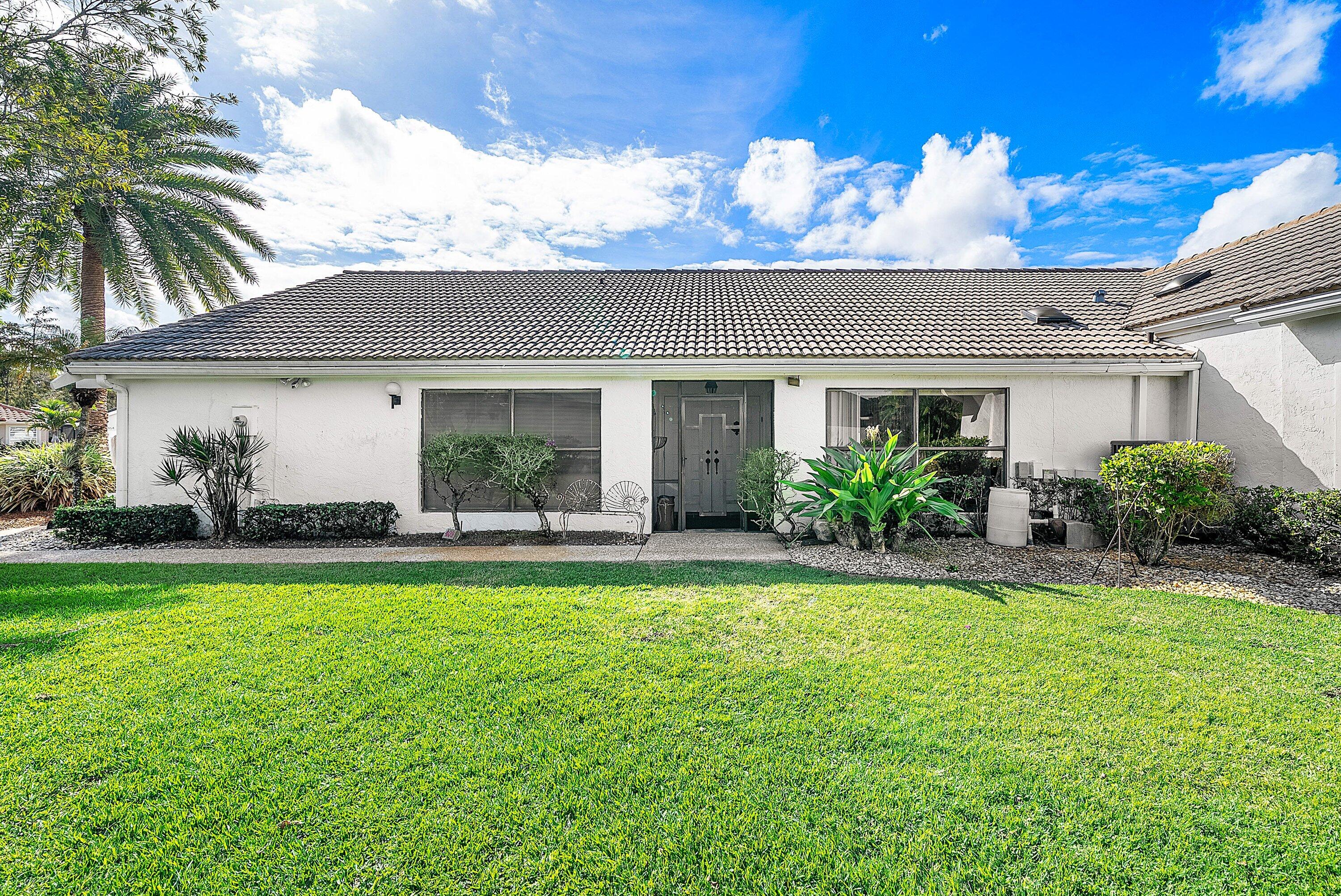 21459 Bridgeview Drive Boca Raton, FL 33428 - Photo 5 of 61 a view of a house with a swimming pool and a yard