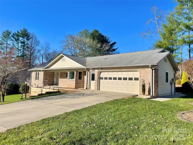 a front view of a house with a garden and yard