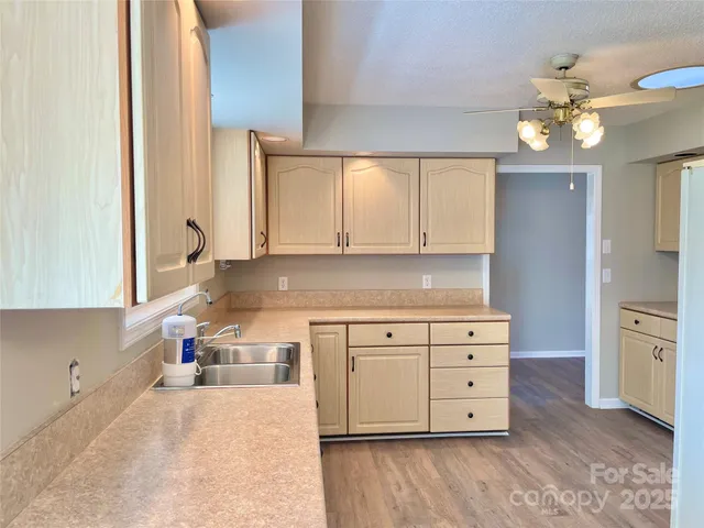 a kitchen with cabinets stainless steel appliances and a window