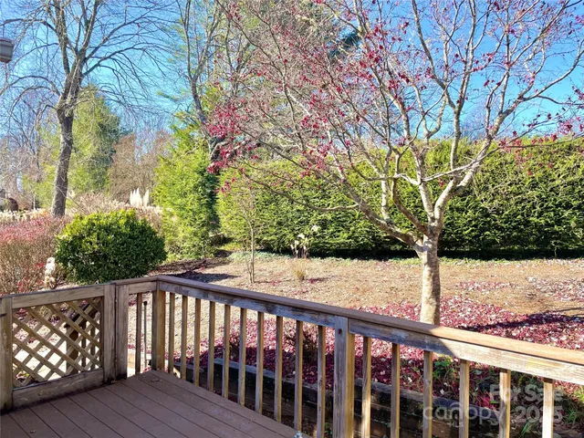 a view of balcony with wooden floor and fence
