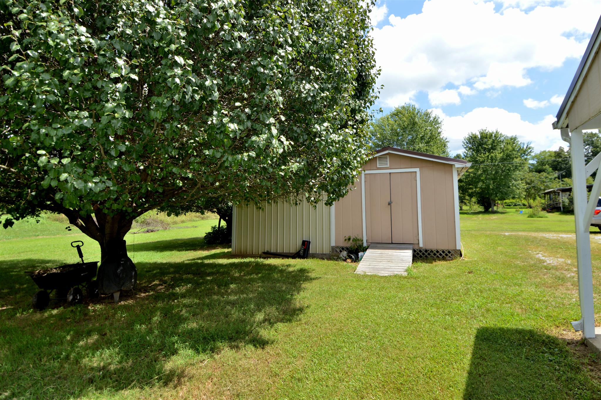 4579 Beech Log Road Lebanon, TN 37090 - Photo 20 of 30 a backyard of a house with plants and large tree