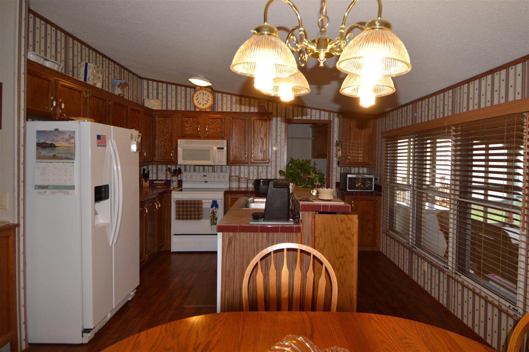 4579 Beech Log Road Lebanon, TN 37090 - Photo 4 of 30 a kitchen with stainless steel appliances granite countertop a refrigerator a stove a sink dishwasher and wooden cabinets
