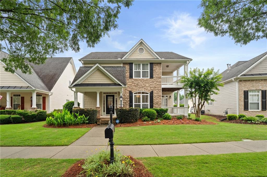 878 Scales Road Suwanee, GA 30024 - Photo 1 of 17 a front view of a house with a yard