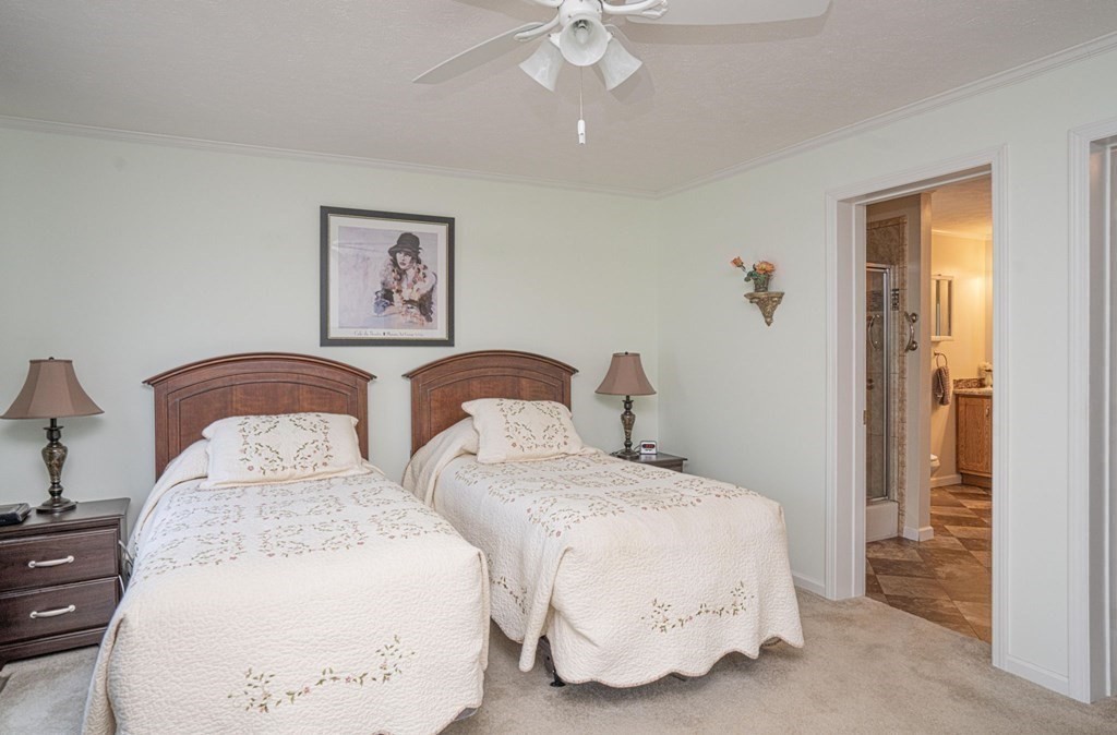 18 Linsay Drive Raynham, MA 02767 - Photo 27 of 41 a bedroom with two beds and a chandelier
