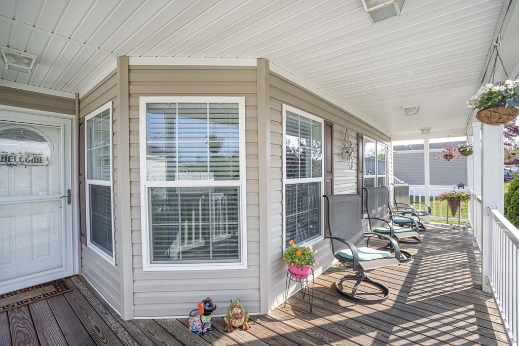 18 Linsay Drive Raynham, MA 02767 - Photo 3 of 41 a view of a patio with table and chairs wooden floor and fence