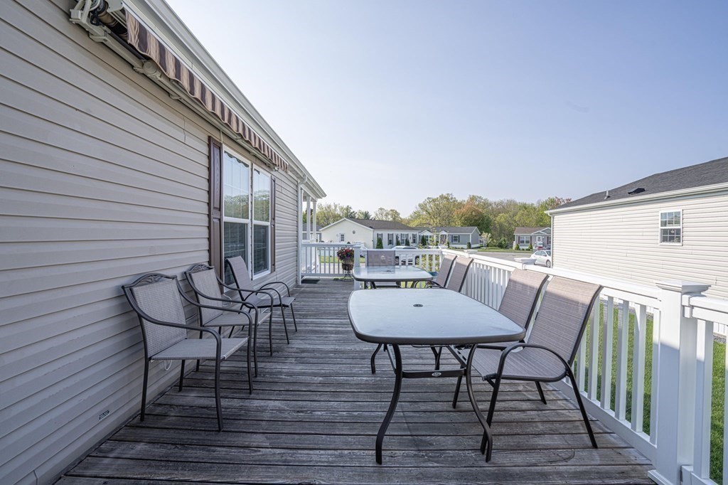 18 Linsay Drive Raynham, MA 02767 - Photo 34 of 41 a view of a roof deck with table and chairs and wooden floor