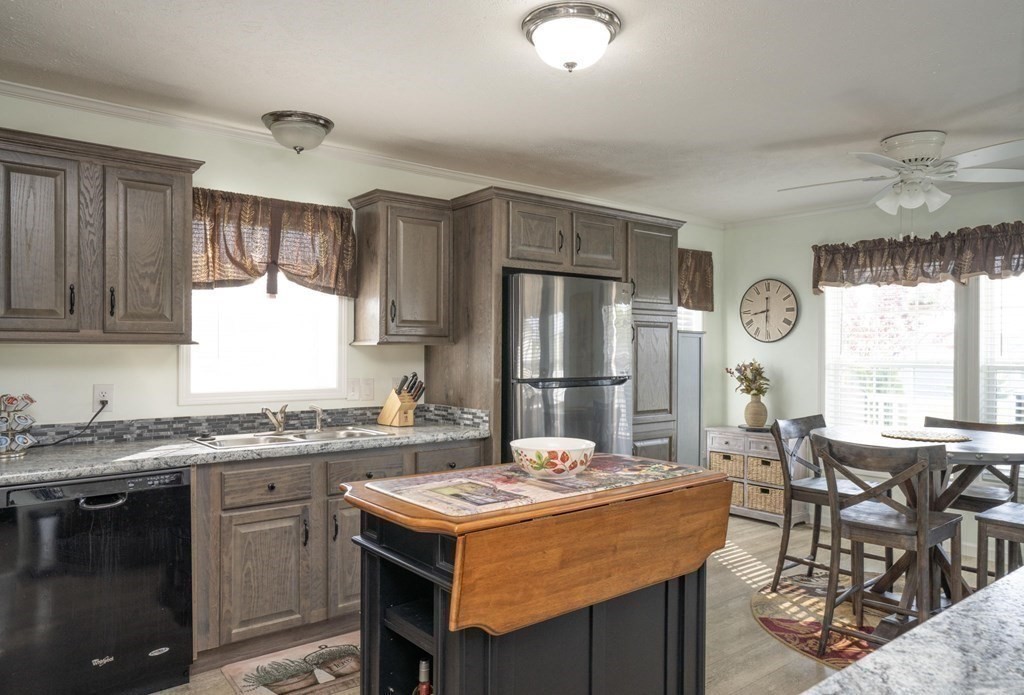 18 Linsay Drive Raynham, MA 02767 - Photo 5 of 41 a kitchen with granite countertop a sink stove and cabinets