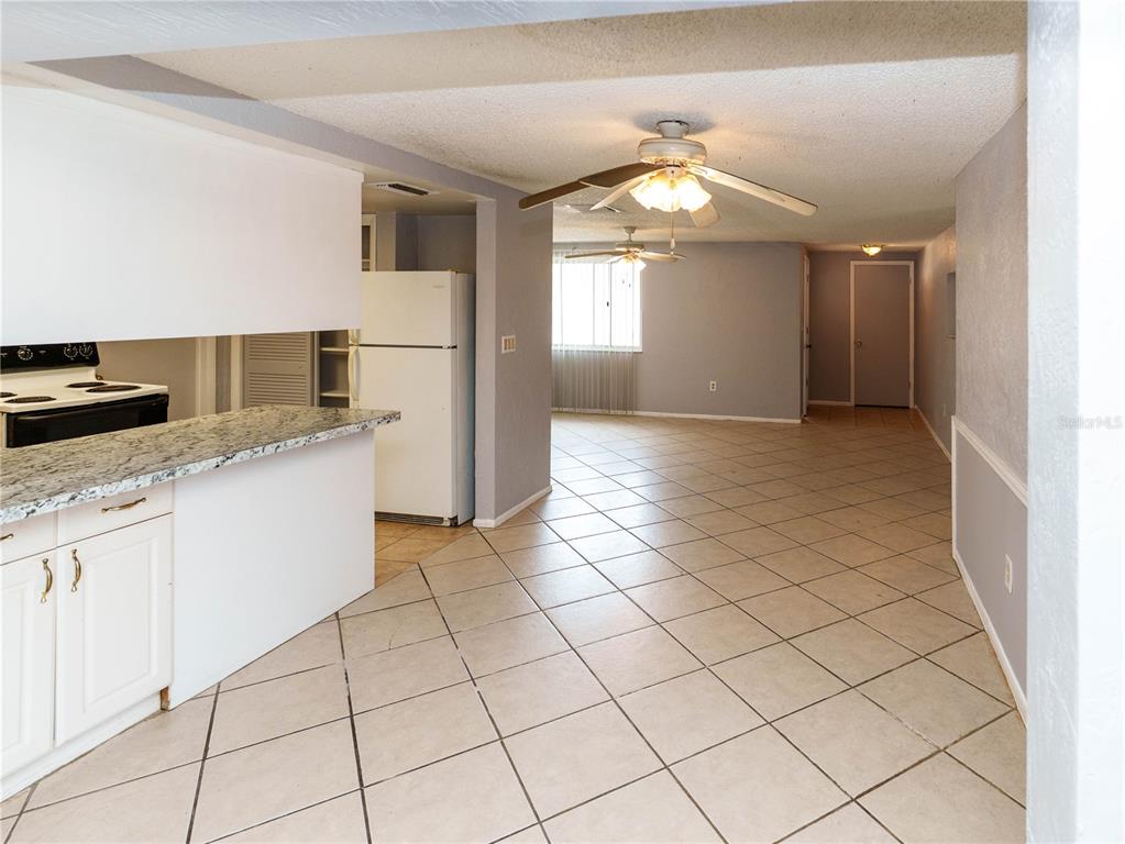 4150 Newbury Drive New Port Richey, FL 34652 - Photo 13 of 32 a view of a kitchen with a sink and dishwasher a refrigerator with white cabinets