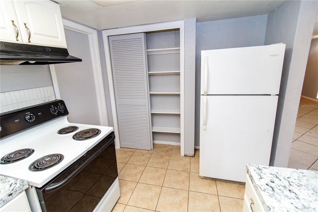 4150 Newbury Drive New Port Richey, FL 34652 - Photo 15 of 32 a kitchen with a refrigerator and a stove
