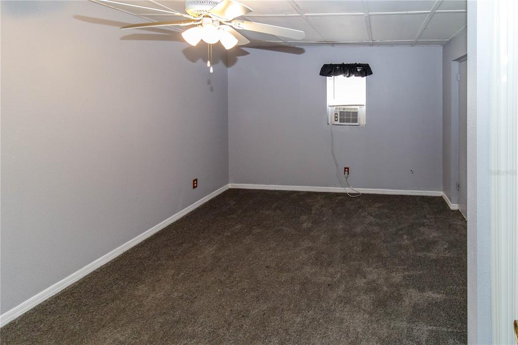 4150 Newbury Drive New Port Richey, FL 34652 - Photo 17 of 32 an empty room with windows and fan