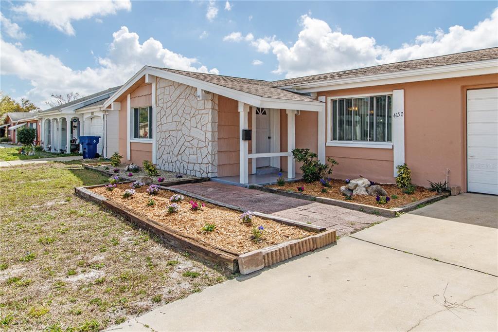 4150 Newbury Drive New Port Richey, FL 34652 - Photo 22 of 32 a front view of house with yard outdoor seating and barbeque oven