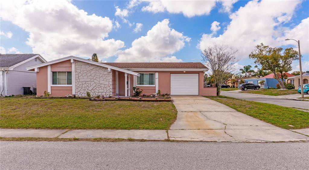 4150 Newbury Drive New Port Richey, FL 34652 - Photo 24 of 32 a front view of house with yard