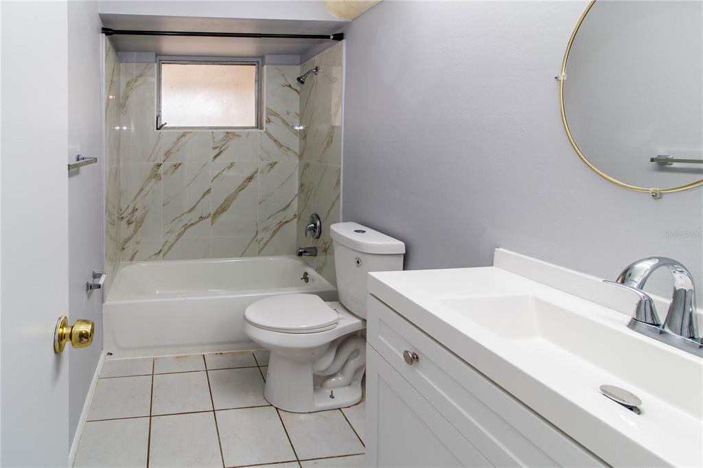 4150 Newbury Drive New Port Richey, FL 34652 - Photo 6 of 32 a bathroom with a sink a toilet and shower