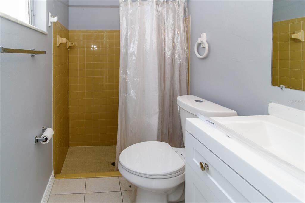 4150 Newbury Drive New Port Richey, FL 34652 - Photo 7 of 32 a bathroom with a sink a toilet and shower