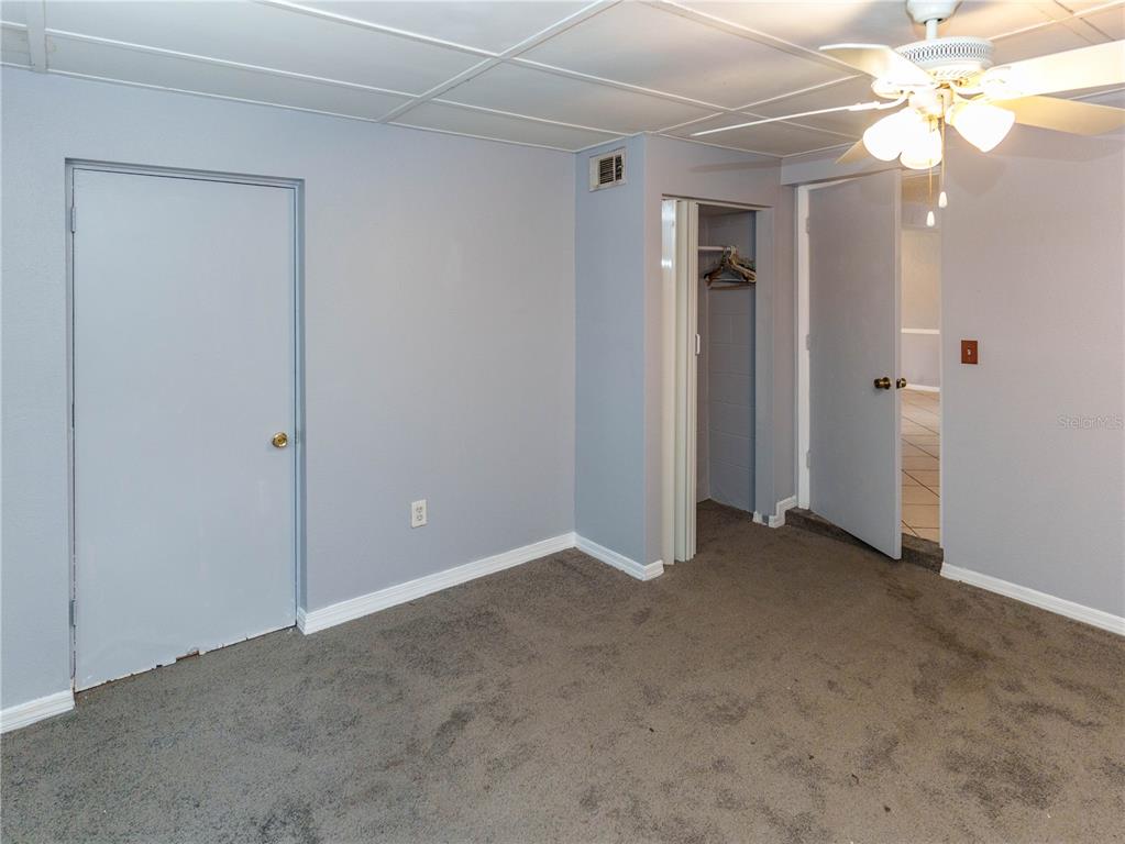 4150 Newbury Drive New Port Richey, FL 34652 - Photo 9 of 32 an empty room with closet and a chandelier fan