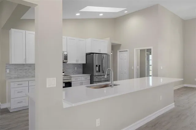 a kitchen with a sink stove and refrigerator