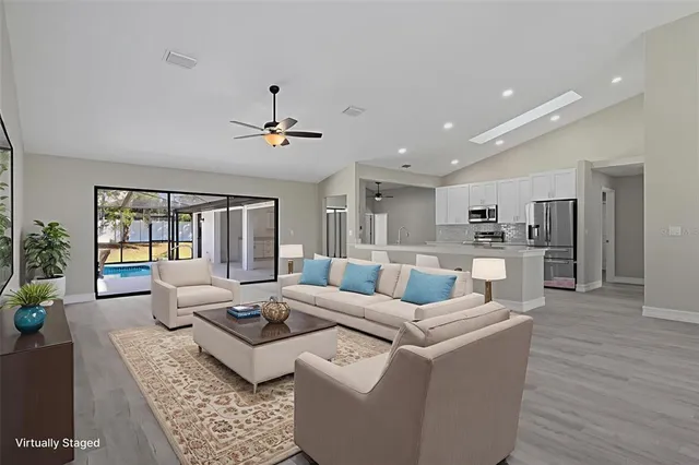 a living room with furniture or kitchen view and a chandelier