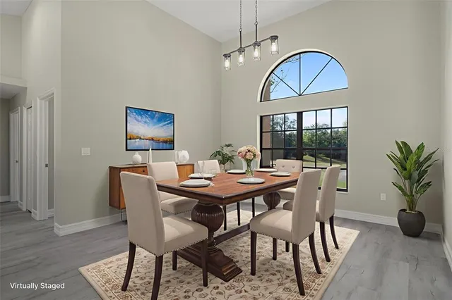 a kitchen with kitchen island white cabinets and stainless steel appliances
