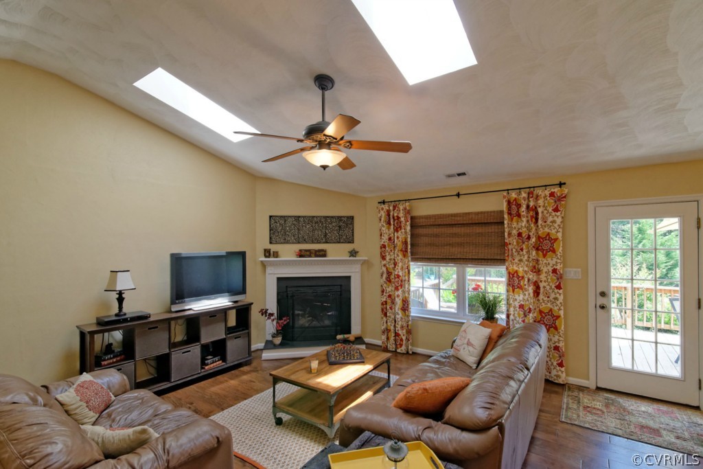 9318 Alcove Grove Road Chesterfield, VA 23832 - Photo 2 of 20 a living room with furniture a flat screen tv and a fireplace