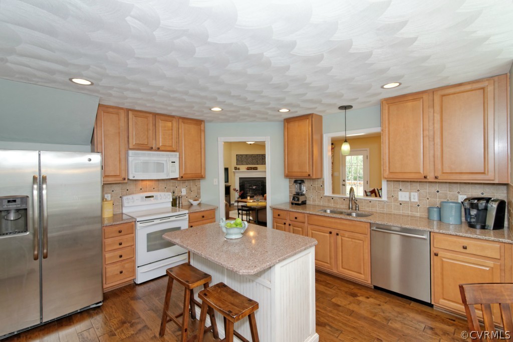 9318 Alcove Grove Road Chesterfield, VA 23832 - Photo 5 of 20 a kitchen with stainless steel appliances kitchen island granite countertop a sink refrigerator and cabinets