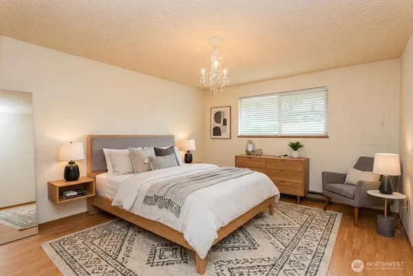 a bedroom with a bed and a chair