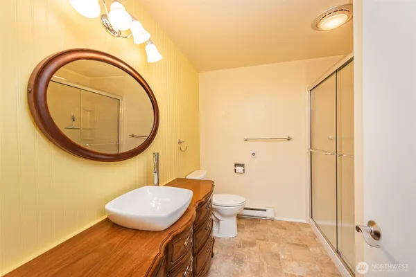 a bathroom with a toilet a sink and a mirror