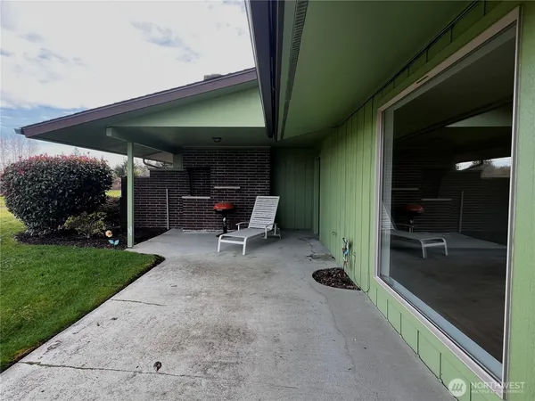 a view of a house with backyard porch and sitting area