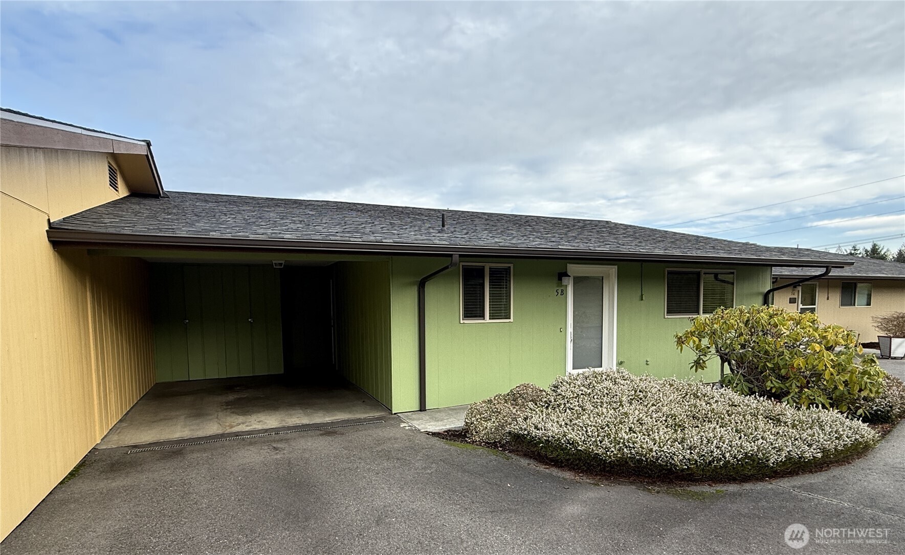 1301 South 3rd Avenue, Unit 5B Sequim, WA 98382 - Photo 21 of 24 a front view of a house with a garage