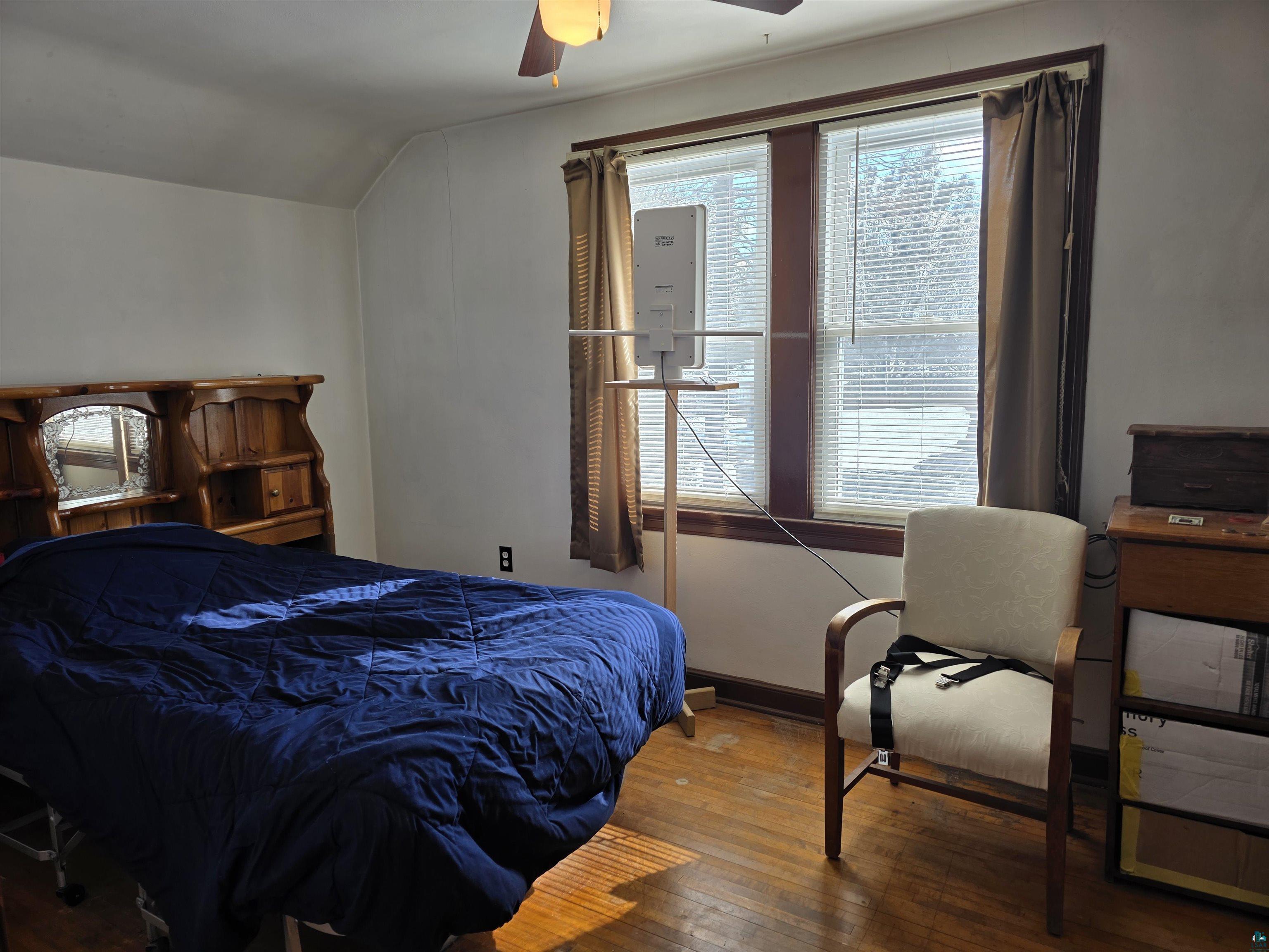 406 North Road Cloquet, MN 55720 - Photo 11 of 26 Bedroom featuring hardwood / wood-style flooring, vaulted ceiling, and ceiling fan