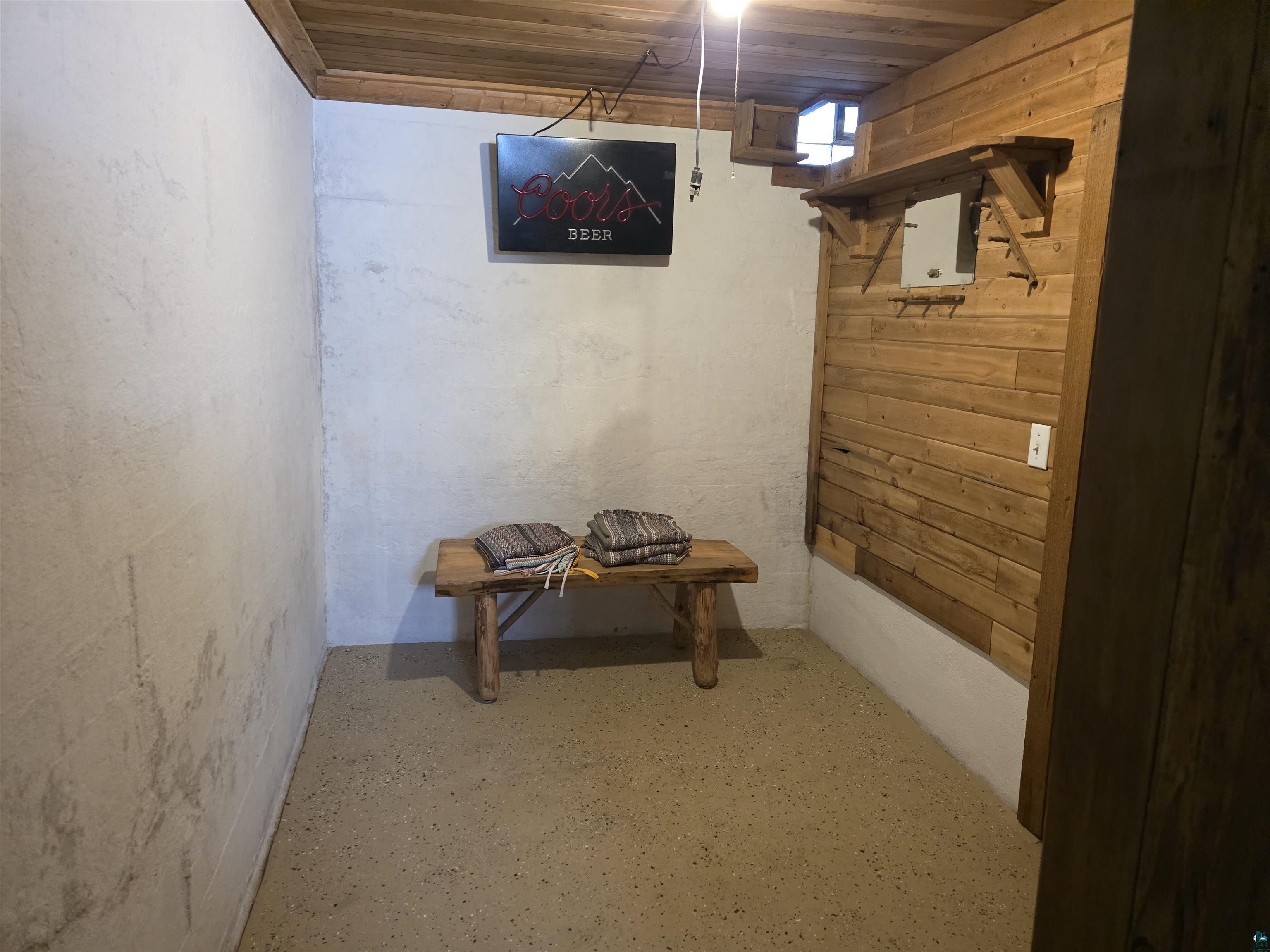 406 North Road Cloquet, MN 55720 - Photo 17 of 26 Hallway with wooden ceiling, wooden walls, and finished concrete floors