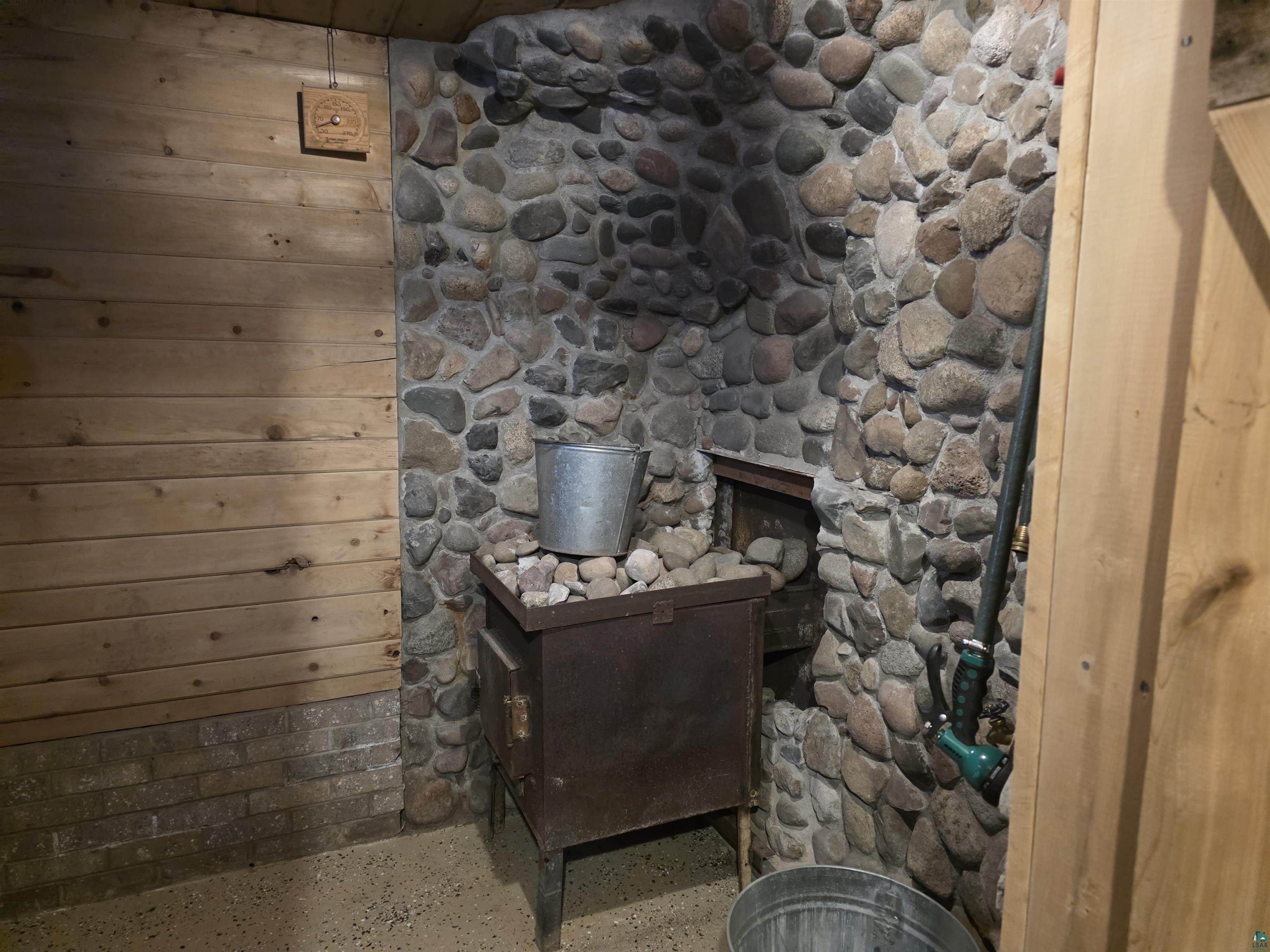 406 North Road Cloquet, MN 55720 - Photo 19 of 26 Detailed view of speckled floor and wooden walls