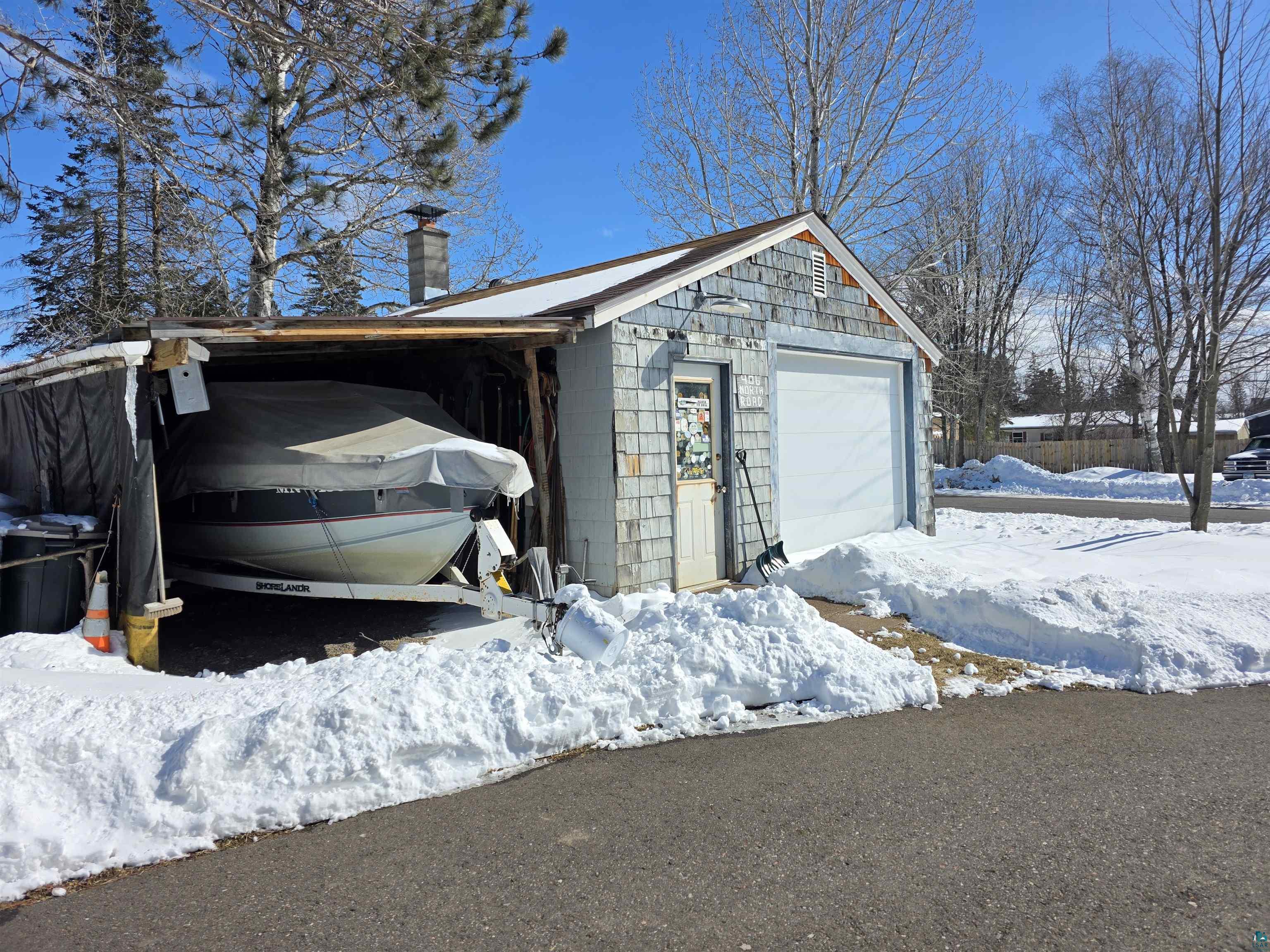 406 North Road Cloquet, MN 55720 - Photo 24 of 26 Snow covered garage with a garage