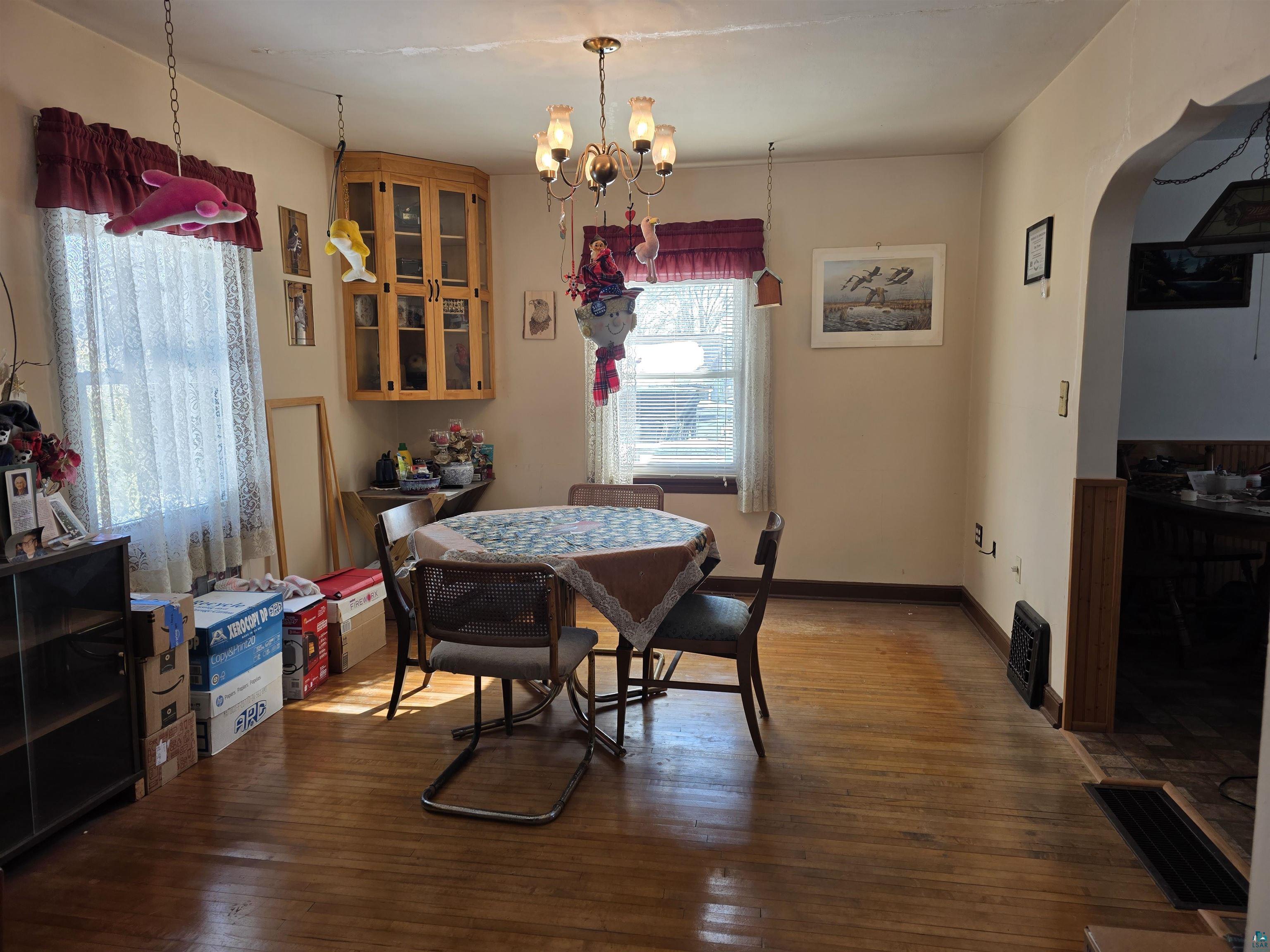 406 North Road Cloquet, MN 55720 - Photo 5 of 26 Dining area with arched walkways, hardwood / wood-style floors, and hanging lights