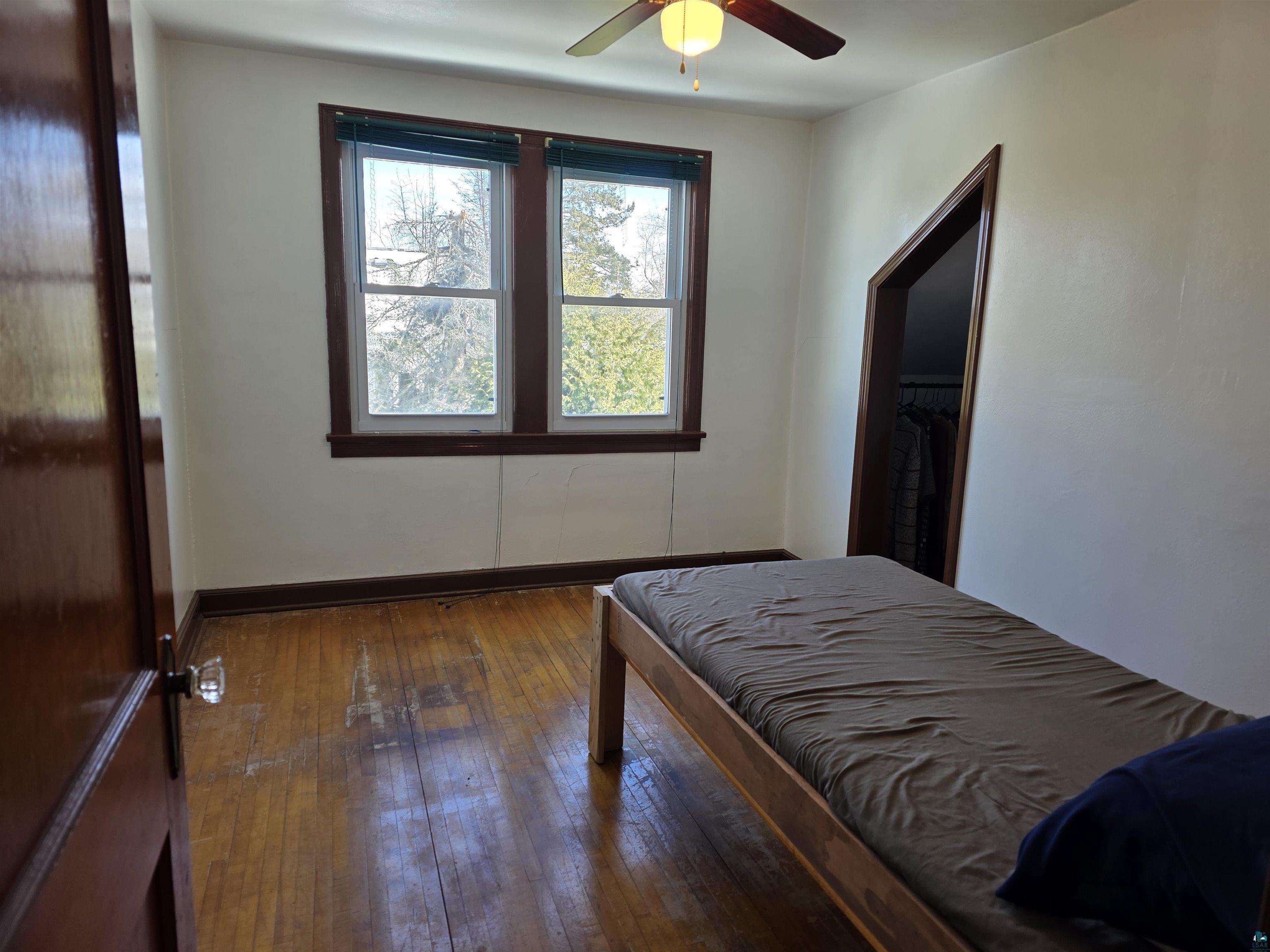 406 North Road Cloquet, MN 55720 - Photo 10 of 26 Bedroom with dark wood finished floors and a ceiling fan
