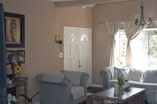 a living room with furniture and a chandelier