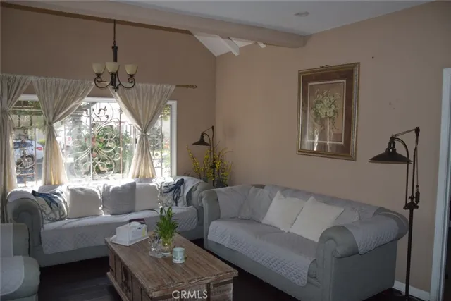 a living room with furniture a window and a chandelier