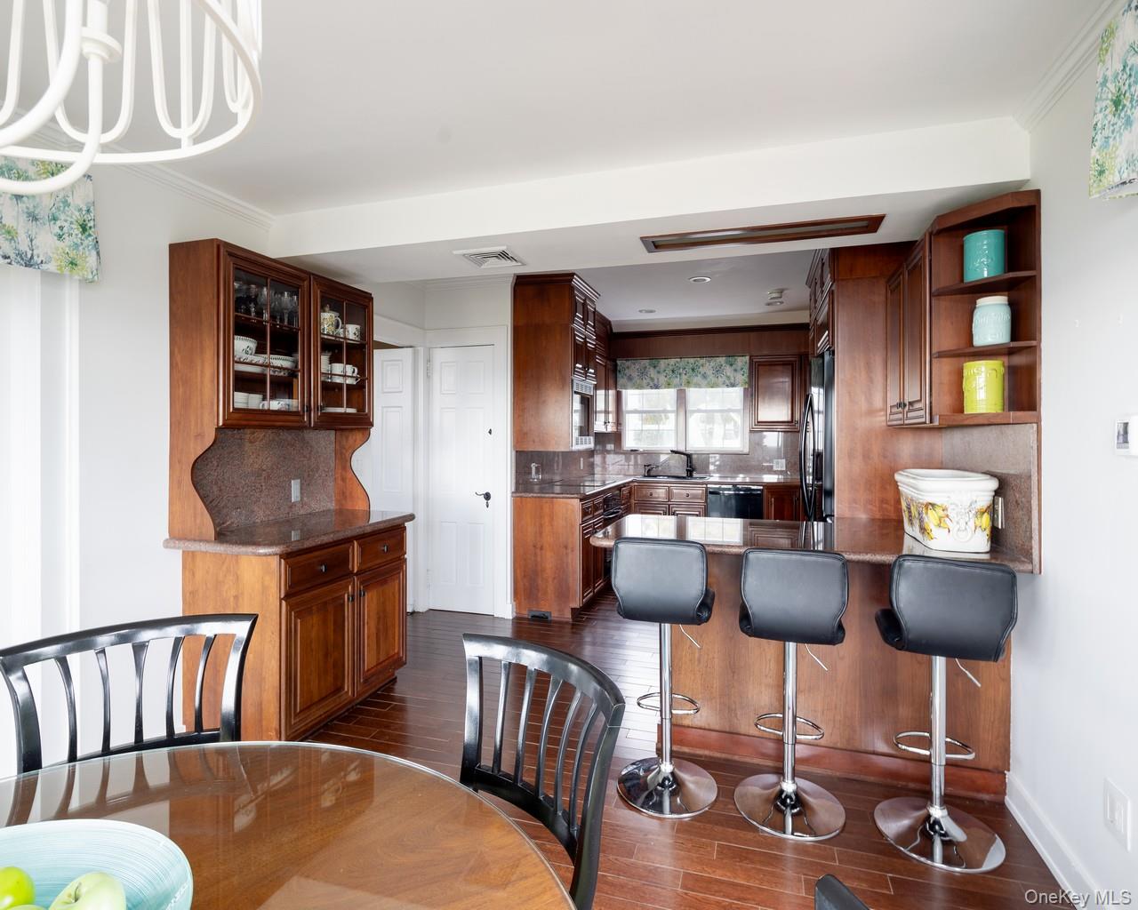 16 Point Road Bellport, NY 11713 - Photo 16 of 33 a dining room with furniture and wooden floor