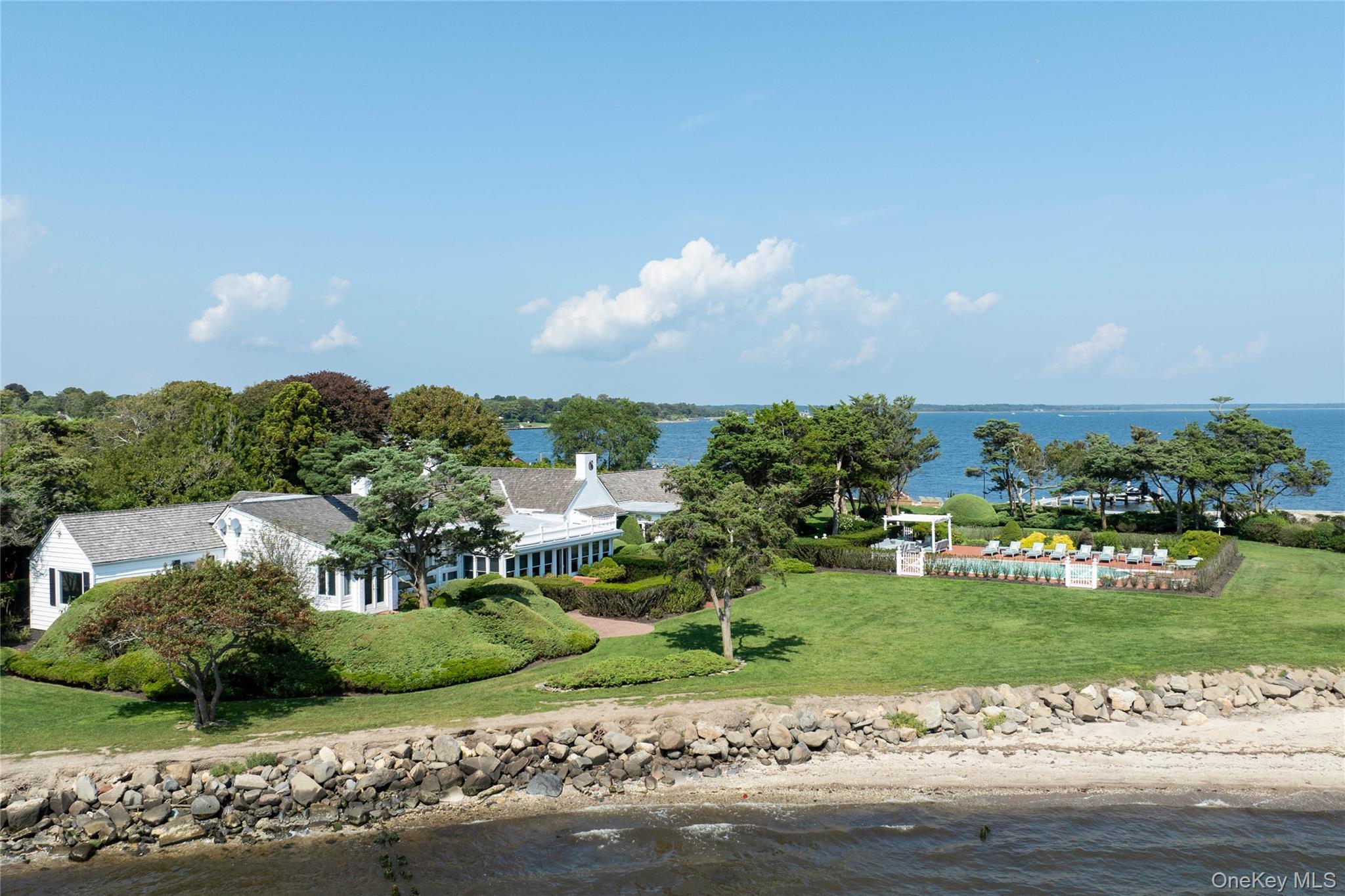 16 Point Road Bellport, NY 11713 - Photo 2 of 33 a view of a garden with a building in the background