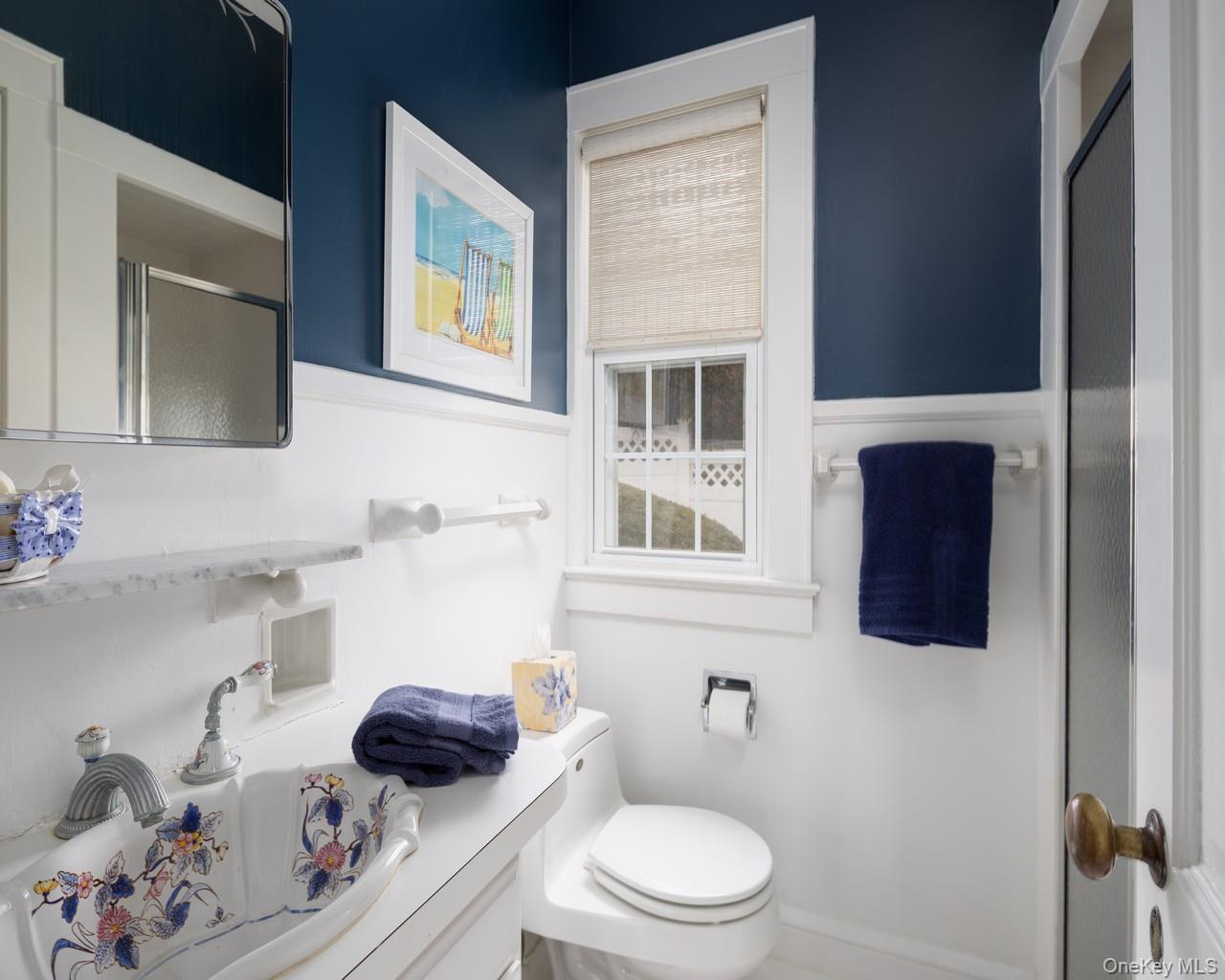16 Point Road Bellport, NY 11713 - Photo 29 of 33 a bathroom with a sink a toilet and shower