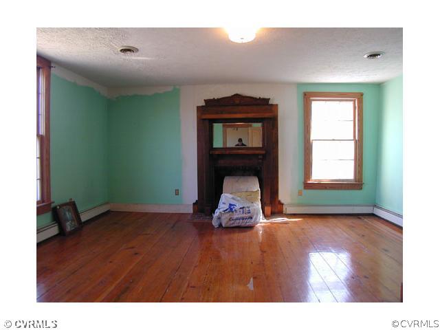 5821 Cox Road Wilsons, VA 23894 - Photo 7 of 12 a living room with a wooden floor and a window