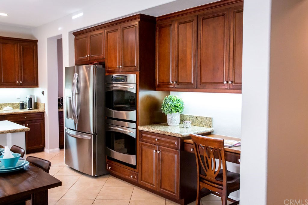 30118 Beeswing Circle Menifee, CA 92584 - Photo 17 of 73 Here you see Upgraded Custom Flooring, Upgraded Custom Wood Cabinetry Office Desk aka Mommy Control Center-Stainless Steel EVERYTHING Double OVENS Granite Everywhere .... this Home is ready for you all you have to do is move in !!