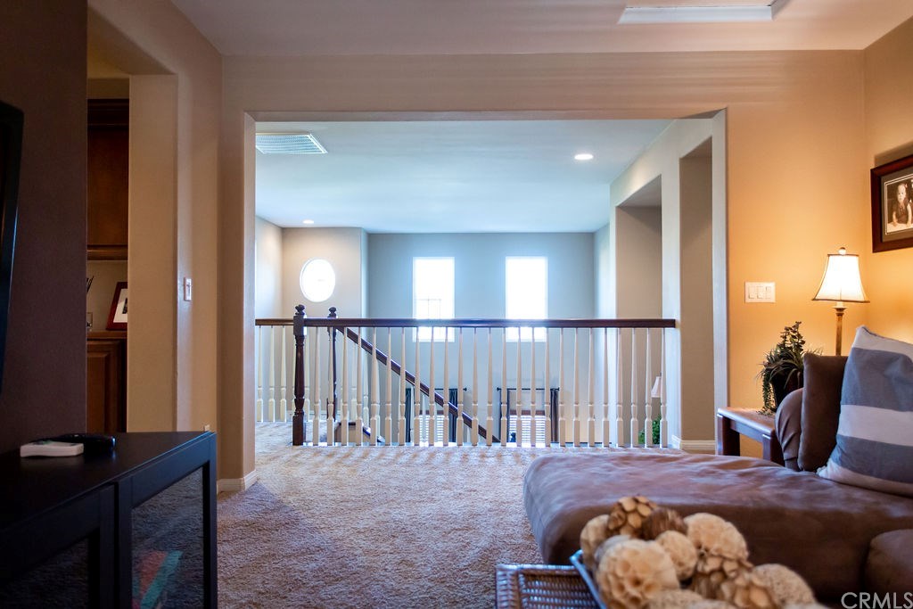 30118 Beeswing Circle Menifee, CA 92584 - Photo 40 of 73 Loft View to the 2 Story High Full Size Windows in the Formal Living Room Windows