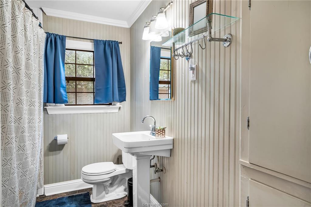 1414 East 29th Street Bryan, TX 77802 - Photo 18 of 21 a bathroom with a sink toilet and a mirror