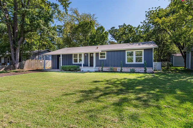 a view of a house with a backyard patio and swimming pool