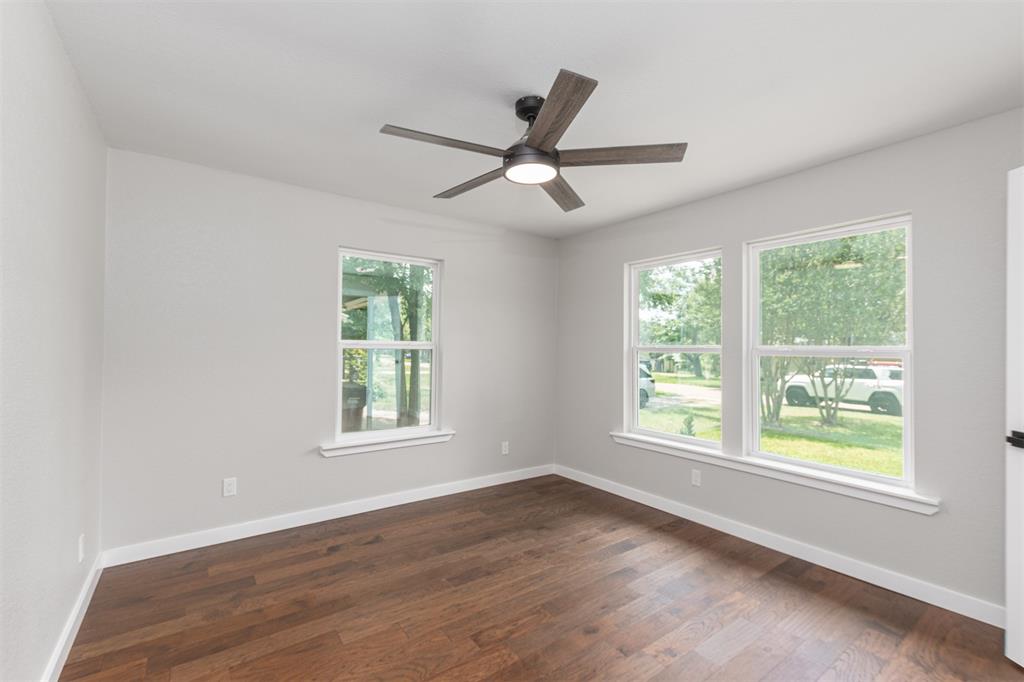 1024 Tower Street Canton, TX 75103 - Photo 11 of 27 a view of an empty room with wooden floor and a window