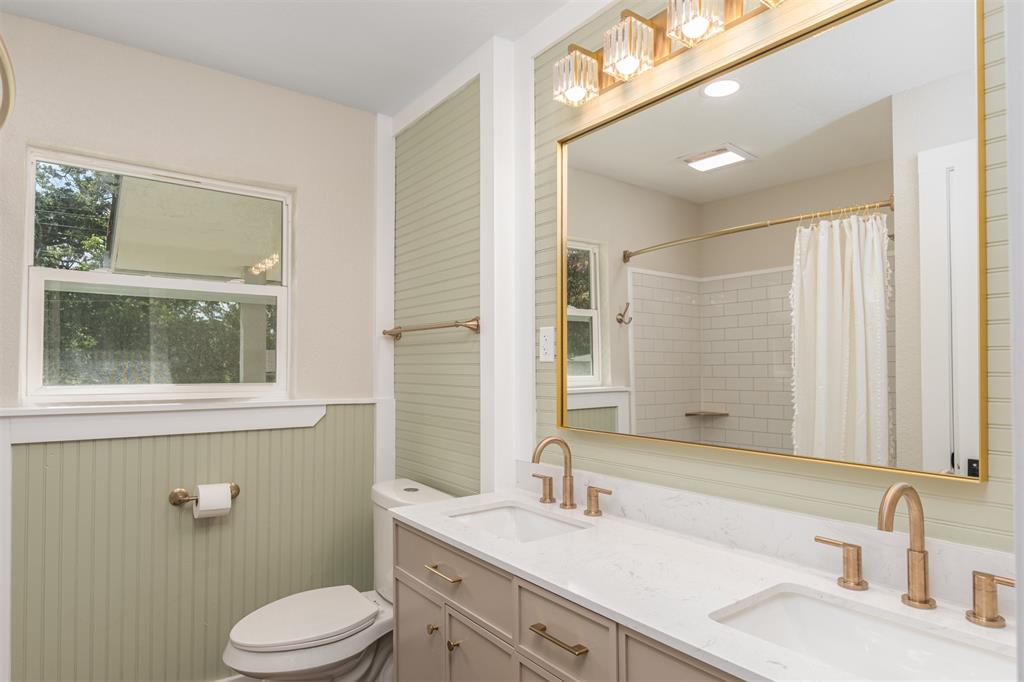 1024 Tower Street Canton, TX 75103 - Photo 13 of 27 a bathroom with a granite countertop sink toilet a large mirror and a shower