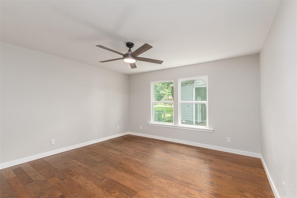 1024 Tower Street Canton, TX 75103 - Photo 14 of 27 an empty room with wooden floor and windows