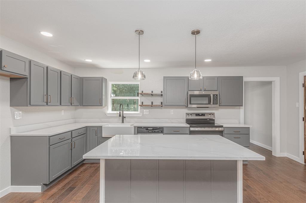 1024 Tower Street Canton, TX 75103 - Photo 4 of 27 a kitchen with stainless steel appliances granite countertop a sink a stove and a refrigerator