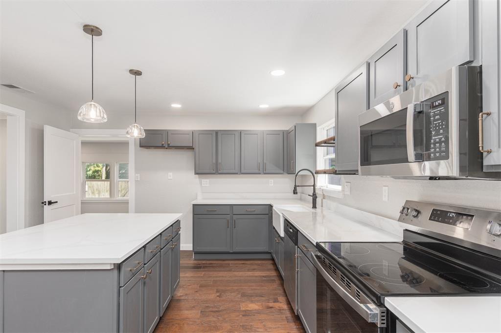 1024 Tower Street Canton, TX 75103 - Photo 5 of 27 a kitchen with stainless steel appliances granite countertop a sink a stove and a wooden floors